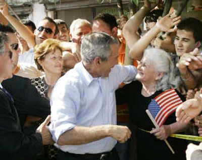 
President Bush talks to a woman holding an American flag in Fushe Kruje, Albania, on Sunday.Associated Press
 (Associated Press / The Spokesman-Review)