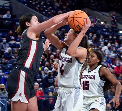 Washington State guard Charlisse Leger-Walker (5) strips the ball from Gonzaga guard Abby O'Connor (4) during the fourth period of an NCAA college basketball game, Wednesday, Dec. 8, 2021, in the McCarthey Athletic Center.  (COLIN MULVANY/THE SPOKESMAN-REVIEW)