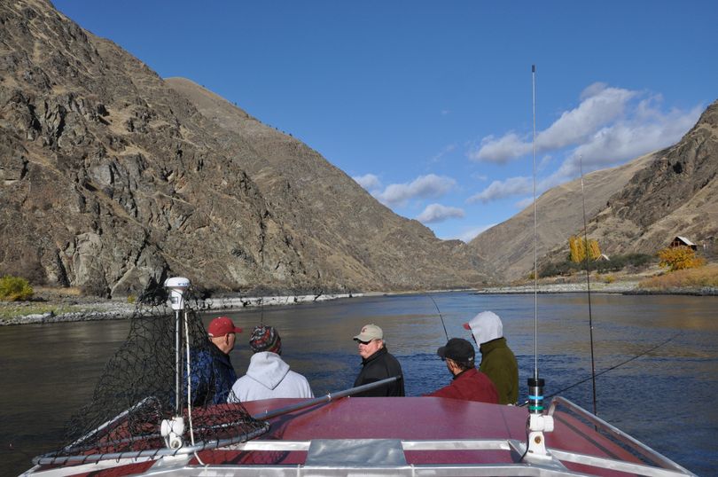 Fishing guide Pete Paolino of Dayton visits with his steelhead fishing clients as he backtrolls their plugs through a hole on the Snake River upstream from the mouth of the Grande Ronde. (Rich Landers)