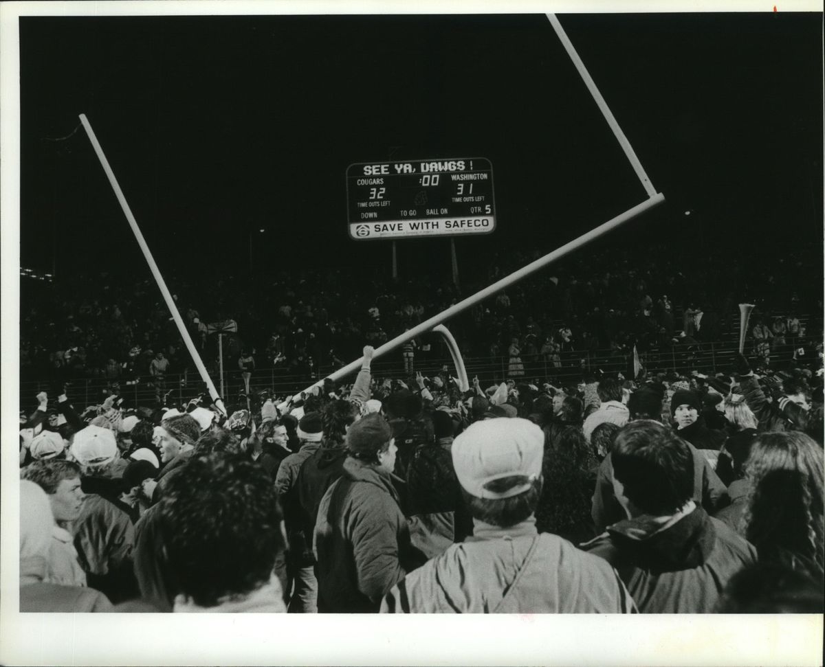 As the postgame chaos erupted in the foreground, the scoreboard said it all after Washington State’s 1988 Apple Cup win (Chris Anderson / Cowles Publishing)