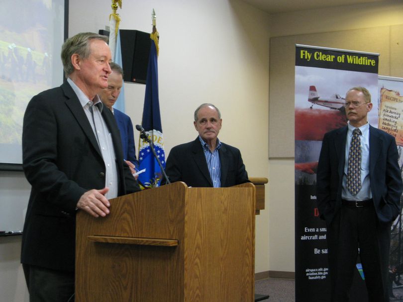 Idaho Sen. Mike Crapo, at podium, joins Oregon Sen. Ron Wyden, Idaho Sen. Jim Risch, and Will Whelan of the Nature Conservancy to call for changes in how Congress funds firefighting, at the National Interagency Fire Center on Wednesday. The three senators are co-sponsoring legislation that's drawn bipartisan support. (Betsy Z. Russell photo)