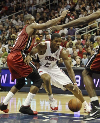 Atlanta’s Joe Johnson works to get around Miami’s Dwyane Wade during the first quarter of Sunday’s Game 7. Atlanta advanced to face Cleveland. (Associated Press / The Spokesman-Review)