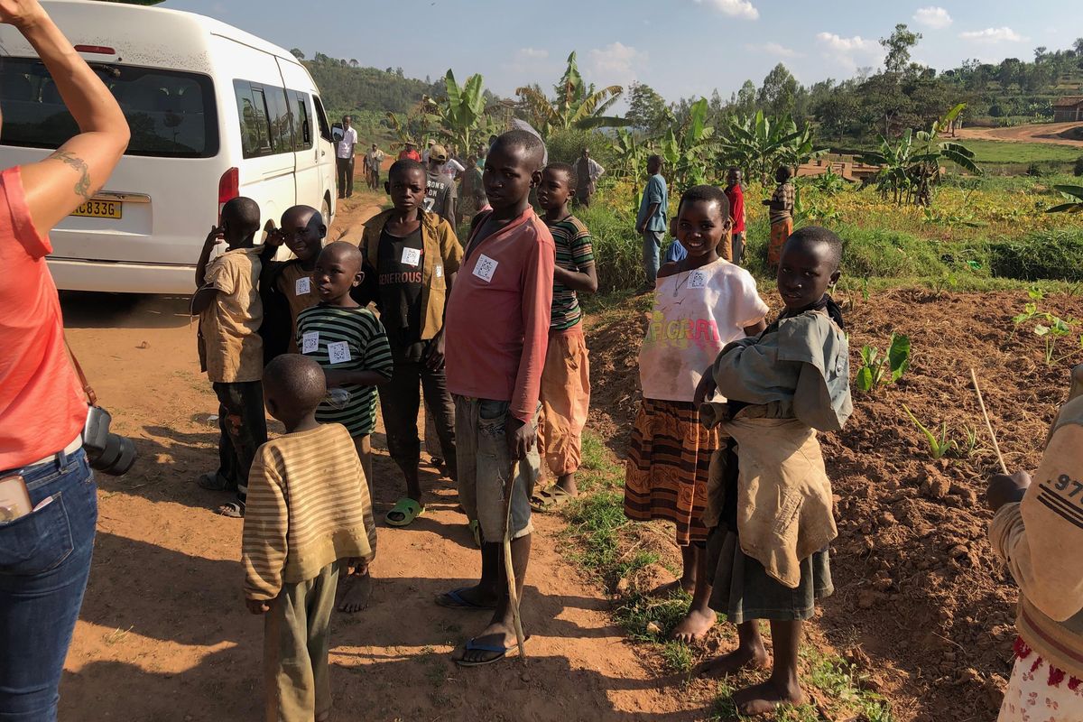 Rwandan children watch as Roast House Coffee owner Deborah Di Bernardo snaps a picture of a bus traveling over a make-shift bridge last month during her trip to the African country. (Deborah Di Bernardo / Courtesy photo)