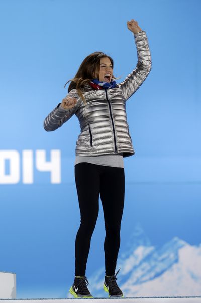 Women's super combined bronze medalist Julia Mancuso of the United States jumps on the podium during the medals ceremony at the 2014 Winter Olympics on Monday. (Associated Press)