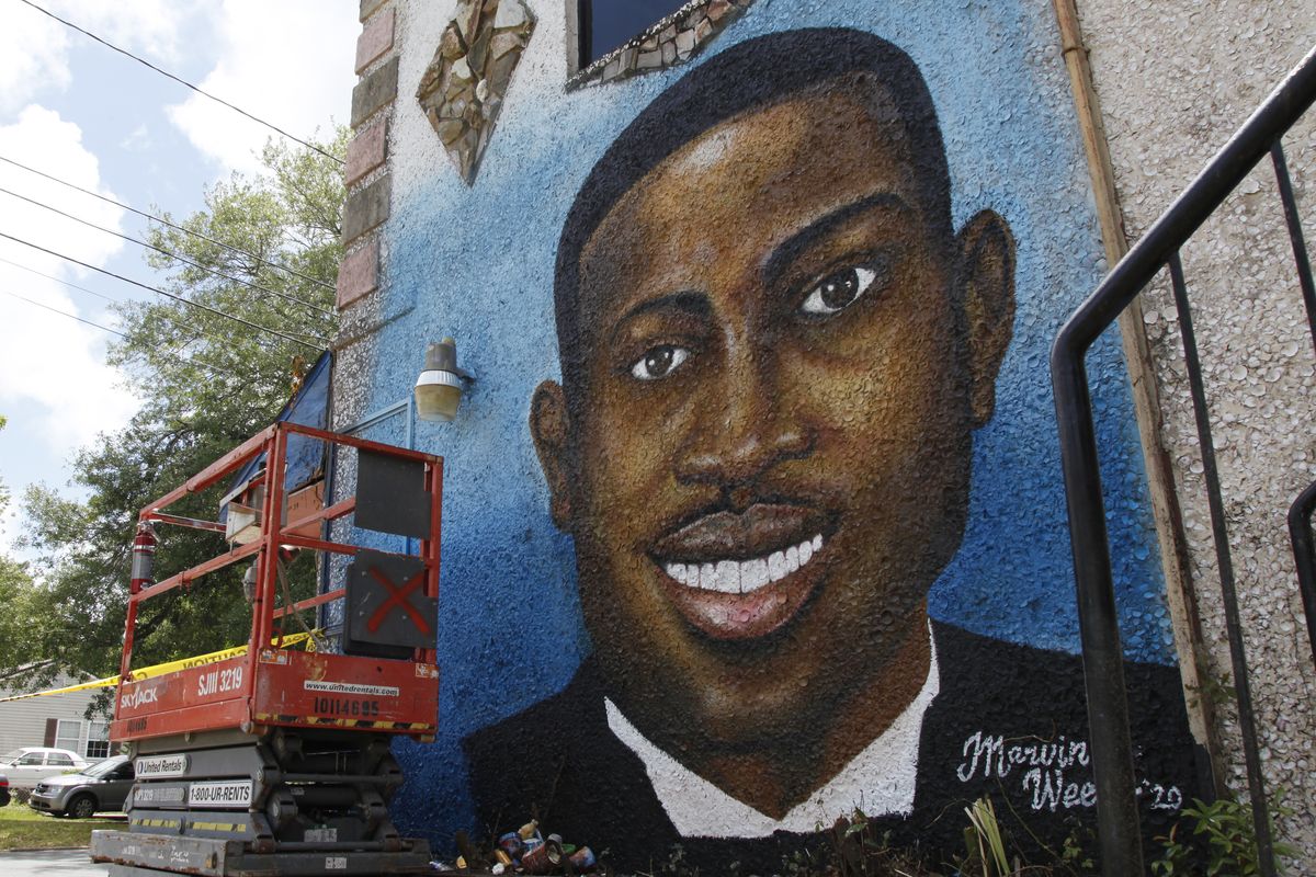 In this May 17, 2020, photo, a recently painted mural of Ahmaud Arbery is on display in Brunswick, Ga., where the 25-year-old man was shot and killed in February. It was painted by Miami artist Marvin Weeks.  (Sarah Blake)