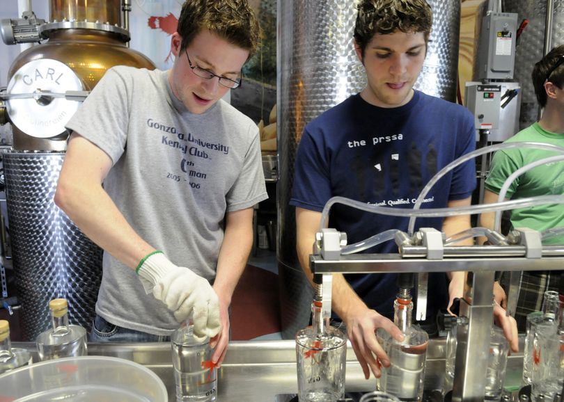 Volunteer bottlers Dash Tokar and Jonathan Manfredonia fill bottles with gin and cork them Saturday, May 16, 2009, at Dry Fly Distilleries, a small-batch producer of gin, whiskey and vodka in Spokane. The company offers volunteers a chance to be the bottling crew on Saturdays, and the schedule is booked to the end of the year. (Jesse Tinsley / The Spokesman-Review)