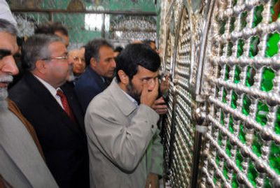 
Iranian President Mahmoud Ahmadinejad, center, reacts emotionally as he stands near the shrine of the prophet Muhammad's grandson, al-Husseim, at the Ommayad Mosque in Damascus, Syria, on Friday. 
 (Associated Press / The Spokesman-Review)