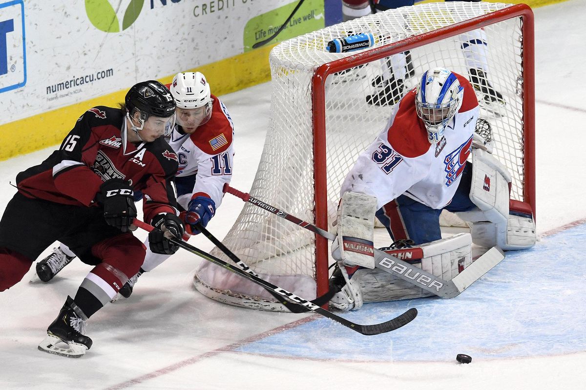 As Vancouver Giants forward Owen Hardy (15) and Spokane Chiefs forward Jaret Anderson-Dolan (11) chase the puck, Spokane Chiefs goalie Bailey Brkin (31) keeps it out of the net during the scoreless first period of a WHL playoff game, Tues., April 23, 2019, in the Spokane Arena. (Colin Mulvany / The Spokesman-Review)