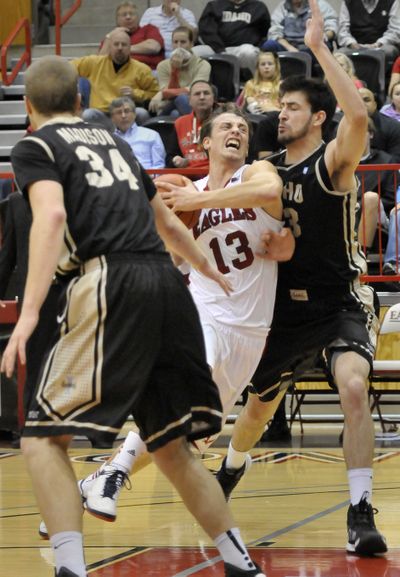 EWU's Thomas Reuter, center, tries to drive between Idaho's Stephen Madison, left, and Kyle Barone, right, on Dec. 6, 2012 at Reese Court in Cheney. (Jesse Tinsley)