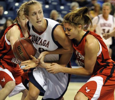 After a loose ball, Gonzaga’s Heather Bowman and EWU’s Julie Piper try to gain control in the first half at McCarthey Athletic Center  during a Dec. 1 game. (Colin Mulvany)
