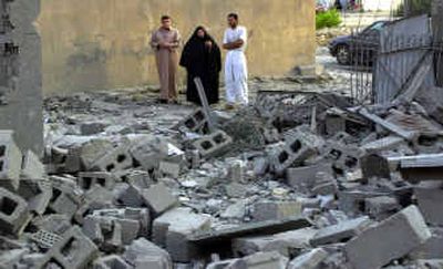 
Iraqis inspect a destroyed building Tuesday in Fallujah, Iraq, after U.S. troops pounded the city with airstrikes, destroying one house and damaging three others. 
 (Associated Press / The Spokesman-Review)