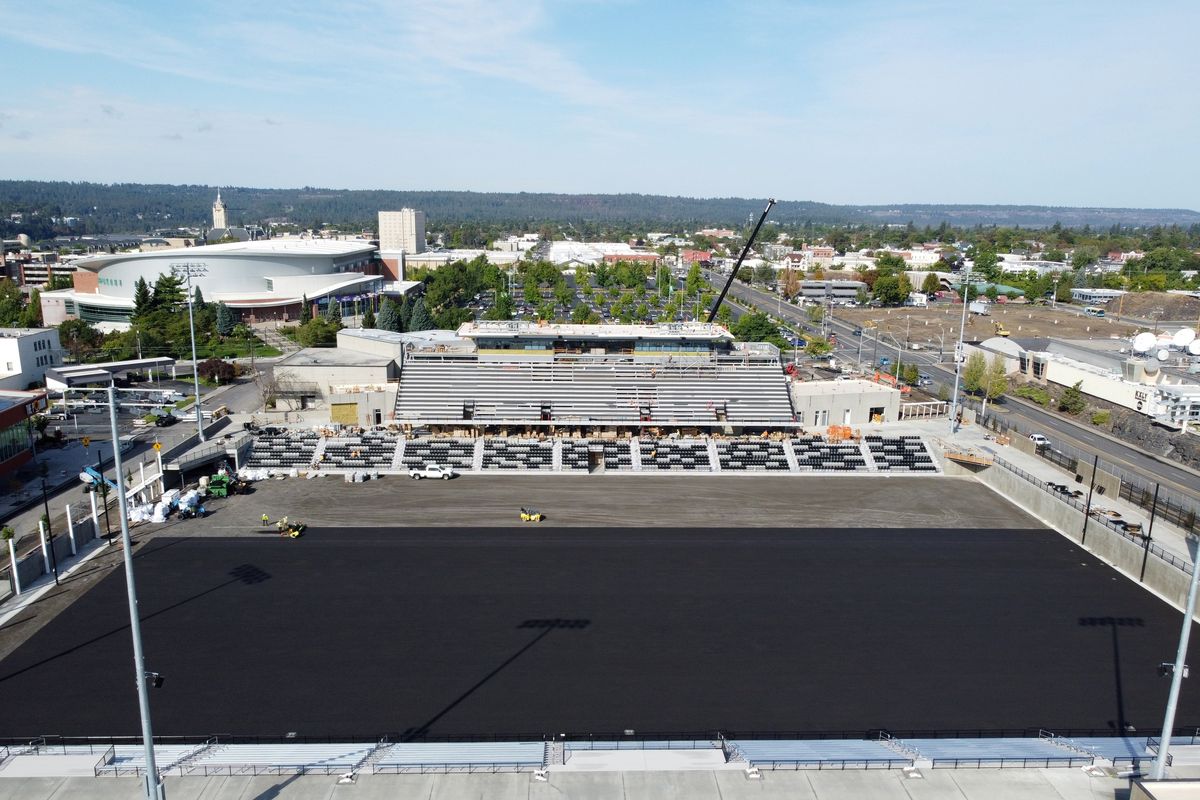 Workers lay a rubberized layer over the field area of Spokane ONE Stadium on Friday as the new facility is readied for its first use later this month. The surface will be covered with modern artificial turf.  (Jesse Tinsley/THE SPOKESMAN-REVI)