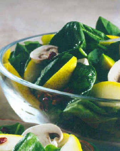 
Bartlett Pear and Spinach Salad combines pears with smoky bacon, avocados and sweet dried cranberries.
 (Associated Press / The Spokesman-Review)