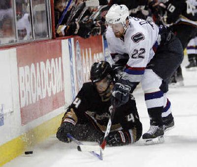 
Anaheim's Rob Niedermayer gets knocked down by Daniel Sedin.  
 (Associated Press / The Spokesman-Review)