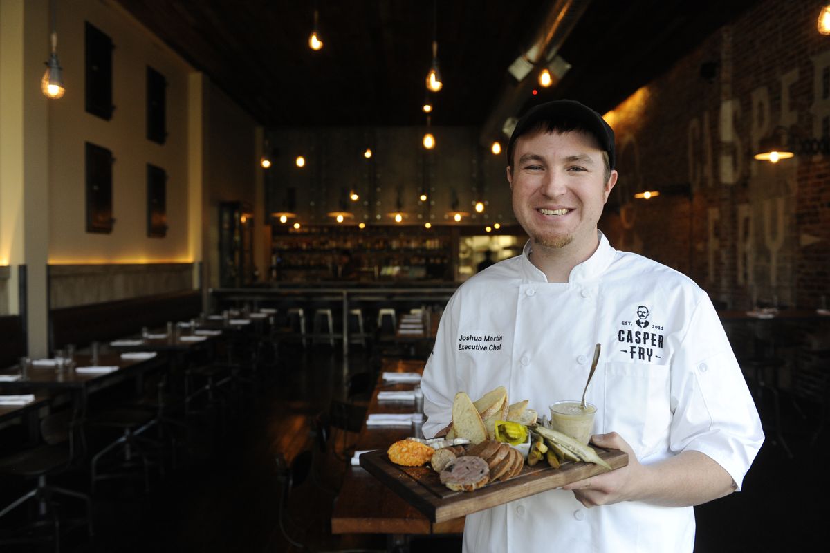 Casper Fry chef Joshua Martin shows off the Pantry Plate, a platter of sausages and pickled vegetables and condiments that are inspired by European cuisine. (Jesse Tinsley)