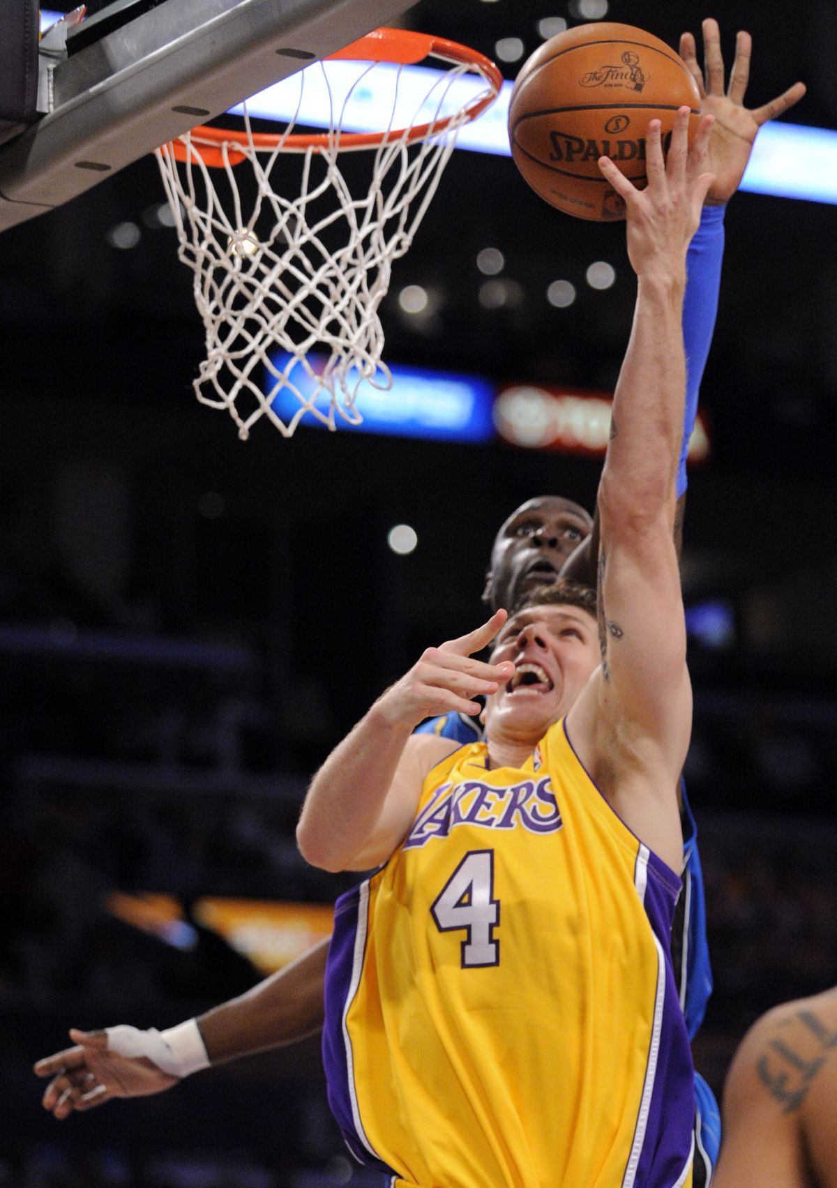 Lakers forward Luke Walton, front, shoots as Magic guard Mickael Pietrus tries for the block in Thursday’s game.  (Associated Press / The Spokesman-Review)