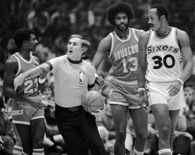 ILE--Referee Earl Strom keeps Houston Rockets Calvin Murphy, left , from getting any closer to Sixers George McGinnis duirng a game in Philadelphia in 1978. Strom, a 29-year NBA official who whistled calls against players from Wilt Chamberlain's generation to Michael Jordan's, died Sunday at his home after a long illness at the age of 66. Strom, who retired after working the 1990 NBA Finals, had undergone surgery in January for a malignant brain tumor. At center is Rockets Dwight Jones. (13) (AP Photo/file)