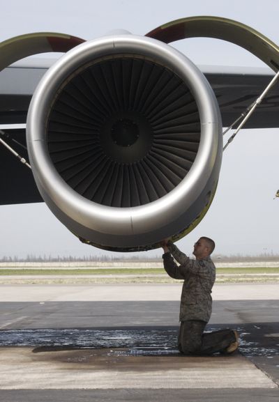 A U.S. serviceman checks equipment at  Manas air base  in Kyrgyzstan on Thursday. The base  has resumed full operations, the U.S. Embassy said Thursday.  (Associated Press)