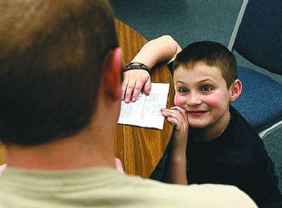 Steele Watson, 10, stares up at Campus Kids mentor Luke Miller during an after-school lesson.
(The Spokesman-Review)