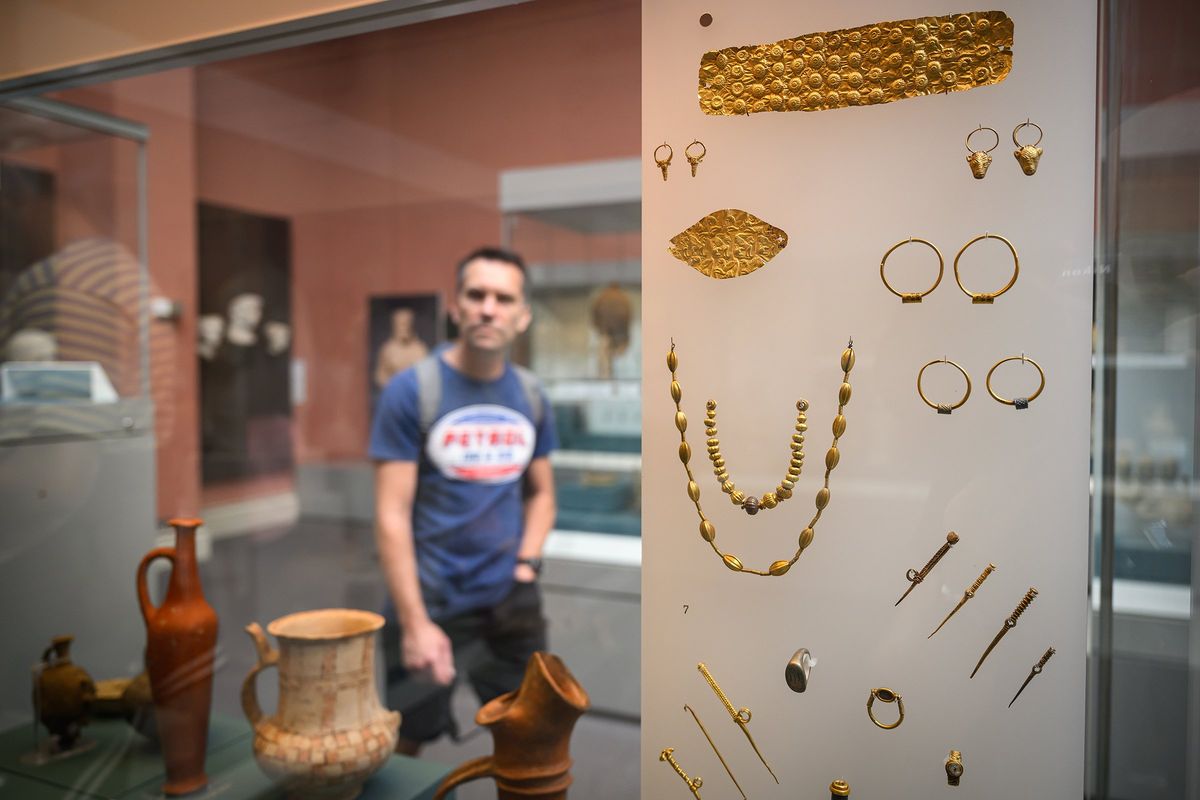 A visitor to the British Museum walks past a display case containing Cypriot jewelery from around 1750BC, on August 23 in London. British Museum officials launched an investigation into the theft of its artifacts after discovering that stolen items, comprising of gold jewelery, semi-precious stones and glass valued at up to £50,000 ($63,000), were being sold on eBay for as little as £40 ($50).  (Leon Neal)