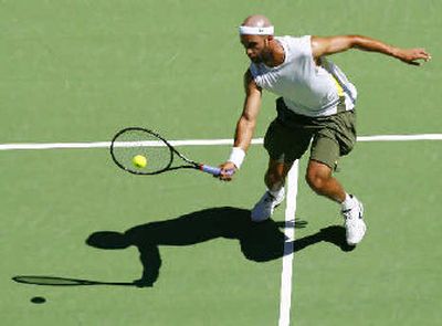 
James Blake returns a shot to Fernando Gonzalez, who claimed a surprising straight-sets victory early today. 
 (Associated Press / The Spokesman-Review)