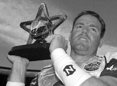 
Cincinnati quarterback Carson Palmer hoists his MVP trophy after the Pro Bowl. 
 (Associated Press / The Spokesman-Review)