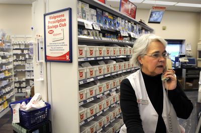 Pharmacy technician Barbara Karst talks with a client Tuesday at the Walgreens at Pines Road and Sprague Avenue in Spokane Valley. The store is one of four in Spokane County that may  stop filling Medicaid prescriptions  because of reduced reimbursement.  (Jesse Tinsley / The Spokesman-Review)