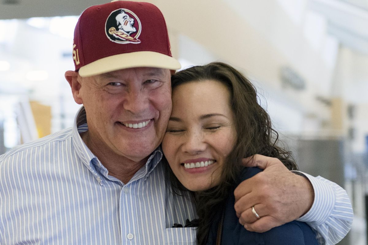 Kim Loan Nguyen, a 46-year-old Amerasian from Vietnam meets her biological father, Donald Bayler, for the first time  Sunday at  Spokane International Airport. (Colin Mulvany / The Spokesman-Review)