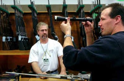 
Marcus Anderson of Newport, Wash., checks out a rifle scope with help from Patrick Adams at Sportsman's Warehouse in Spokane Valley on Friday. 
 (Holly Pickett / The Spokesman-Review)