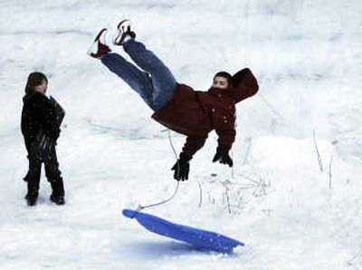 
Daniel Loftice,  16, catches some air after sledding over a jump Friday at Underhill Park. Loftice, a student at Rogers High School, traveled across town to sled. 
 (Dan Pelle / The Spokesman-Review)