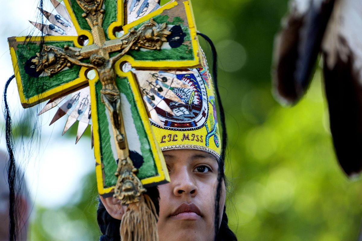 Lil’ Miss Coeur d’Alene, Nikisa Arthur, 15, of Plummer, Idaho, led the procession during the start of the Feast of the Assumption Mass at the 82nd annual Cataldo Pilgrimage at the Old Mission State Park in Cataldo, Idaho, Monday. (Kathy Plonka / The Spokesman-Review)