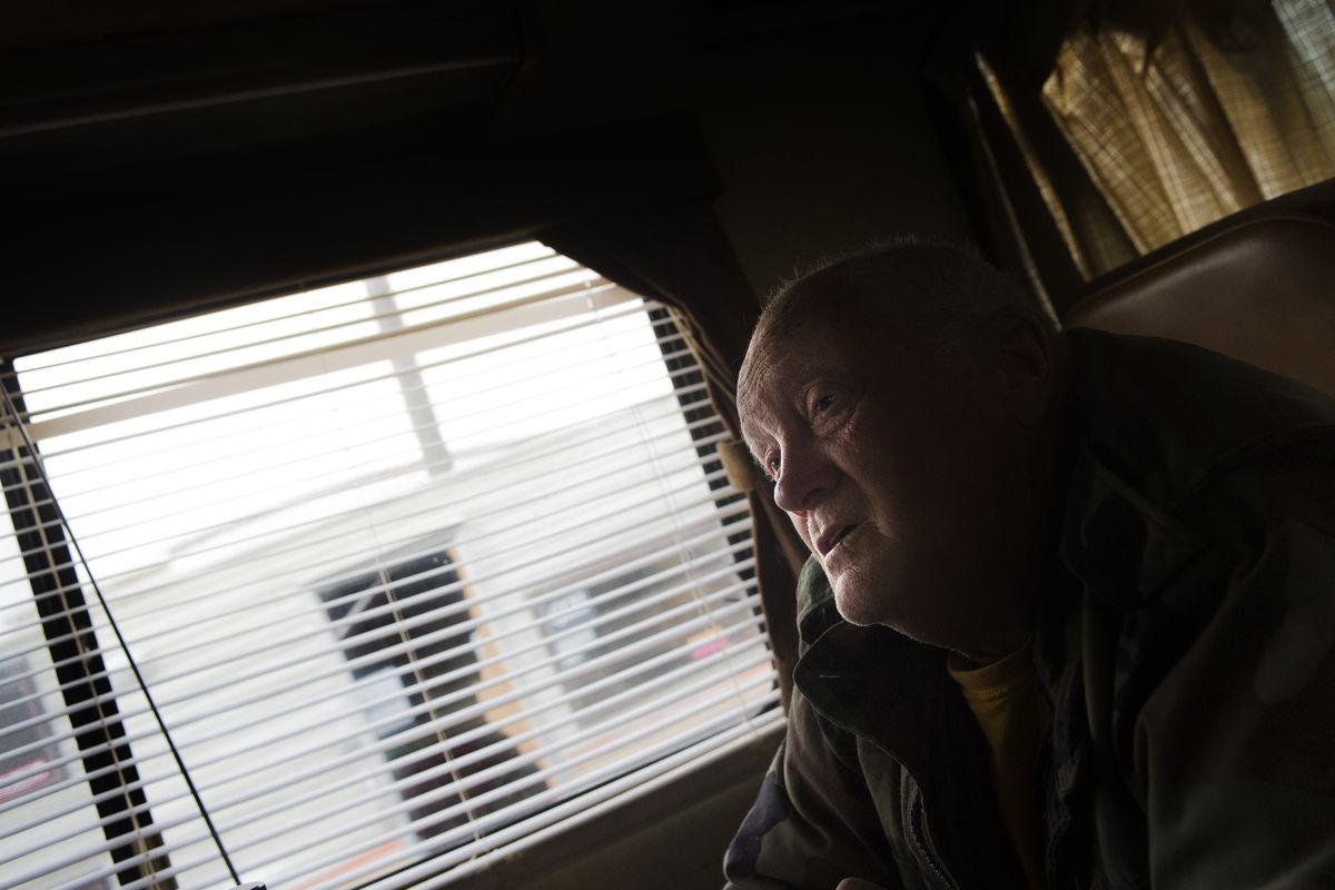 Jerry McDowell talks with the media Wednesday while relaxing in a trailer he says he bought for $500 before parking it on his property in Mead. The county is moving to seize the property, where authorities busted meth labs in 2009 and 2011. (Tyler Tjomsland)