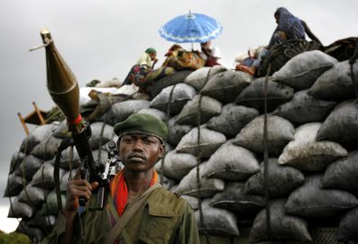 Congolese government forces man the front line  as a truck carrying goods from the rebel-controlled north stops to fix a tire Sunday near Kibati.  (Associated Press / The Spokesman-Review)
