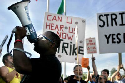 
Samuel Hargrove chants into a megaphone while waiting outside the Machinists union building in Everett, Wash., to vote Thursday on whether to accept the latest Boeing Co. contract offer.  
 (Associated Press / The Spokesman-Review)