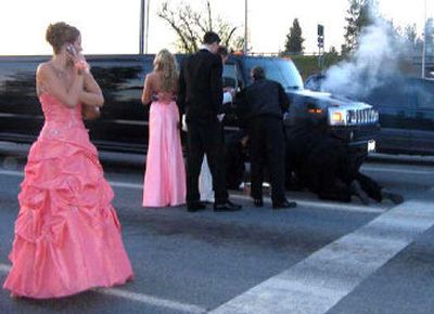
A limousine carrying 16 young people and headed for the Post Falls High School prom last Saturday  was stranded in traffic after a fire broke out in a wheel well. Promgoers from left are: Tracy Erickson, Dana Werner, Jake Bonwell and Travis Wasileski. 
 (Courtesy of Cara Collins / The Spokesman-Review)