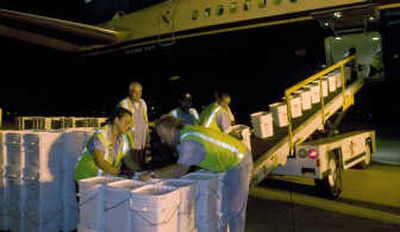 
Ground crew members unload more than 17 tons of silver coins in May  found in a shipwreck. Associated Press/Photo courtesy Odyssey marine Exploration
 (Associated Press/Photo courtesy Odyssey marine Exploration / The Spokesman-Review)