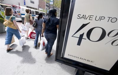 Shoppers on New York’s 34th Street pass a 40 percent off sales sign in front of a Banana Republic store. In a bid to pull frugal shoppers into their stores, the nation’s retailers are slashing their prices on everything from jeans to home appliances. But those 50 percent discounts on jeans and the 60 percent reductions on dinnerware will likely come at a big price for retailers.  (Associated Press / The Spokesman-Review)