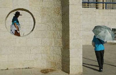
Two women, part of a group of about 2,500 tourists from South Korea, can be seen before a mass prayer in a stadium in Jerusalem on Monday. The tourists, members of a Christian cultural organization, arrived in Jerusalem to attend a convention of the organization and to 