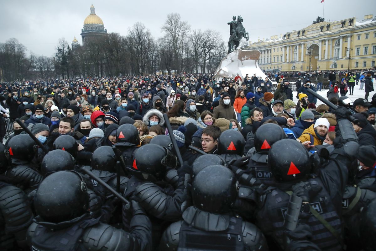 People clash with police during a protest against the jailing of opposition leader Alexei Navalny in St.Petersburg, Russia, Saturday, Jan. 23, 2021. Russian police on Saturday arrested hundreds of protesters who took to the streets in temperatures as low as minus-50 C (minus-58 F) to demand the release of Alexei Navalny, the country