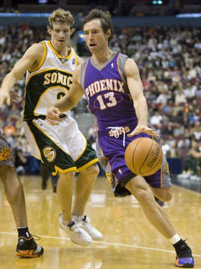 
Suns guard Steve Nash drives past the Sonics' Luke Ridnour on Friday.Associated Press
 (Associated Press / The Spokesman-Review)