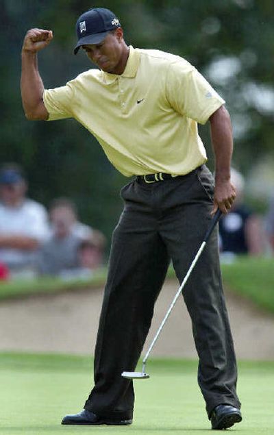 
Tiger Woods reacts on the 14th green after his second eagle at the Buick Open. 
 (Associated Press / The Spokesman-Review)