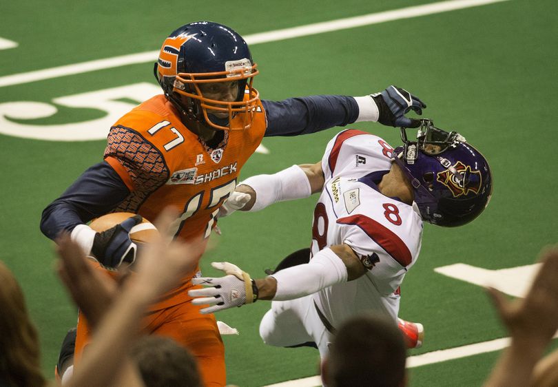 On his way to the end zone, Spokane Shock's Adron Tennell stiff arms New Orleans VooDoo's defensive back Leslie Majors during the second quarter of their AFL game, Friday, May 17, 2013, in the Spokane Arena. (Colin Mulvany / The Spokesman-Review)