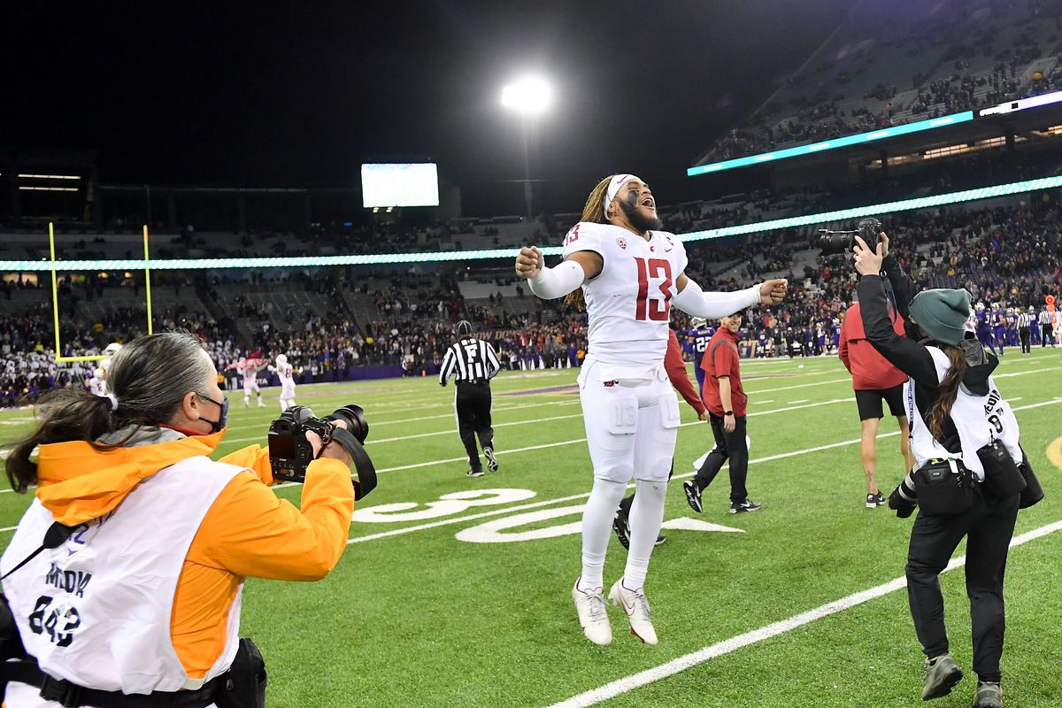 Washington State linebacker Jahad Woods (13) celebrates after the Cougars beat Washington on Nov. 26 at Husky Stadium in Seattle. Woods has received an invite to the Pittsburgh Steelers