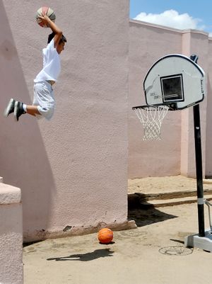  Juan Martinez, 10, leaps off a staircase before slamming the ball into a lowered basketball goal Wednesday, July 22, 2009, at the Boys & Girls Club in Las Cruces, N.M. (AP Photo/Las Cruces Sun-News, Norm Dettlaff) (Norm Dettlaff / The Spokesman-Review)