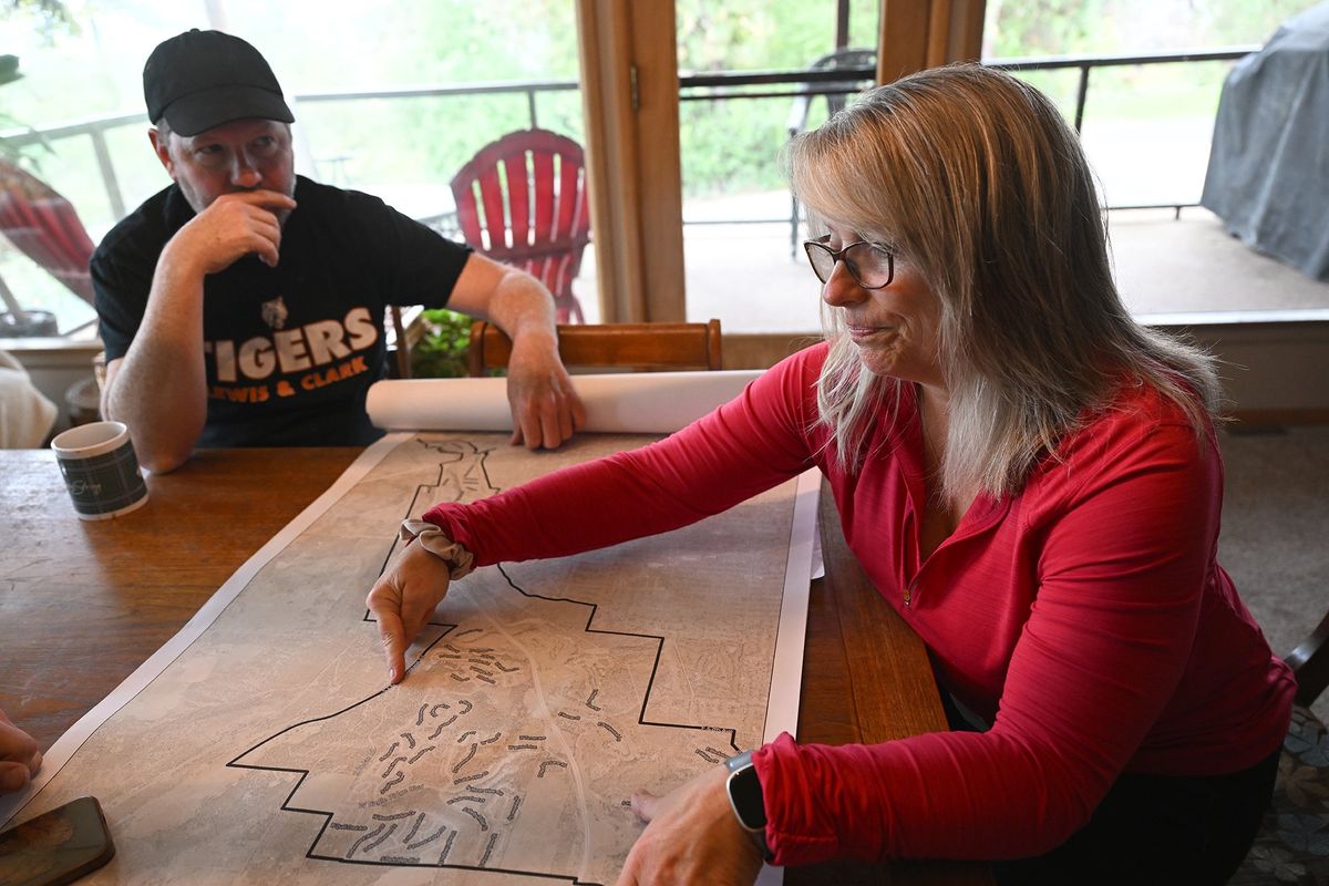 Adam and Molly Marshall talk over the impact of apartment buildings planned for just down the road from them in Latah Valley near U.S. Highway 195, where they say traffic and emergency response will be endangered by the huge influx of residents in the area. They were photographed at their small hillside home Friday. Molly is leading a group opposing the development.  (Jesse Tinsley/THE SPOKESMAN-REVI)