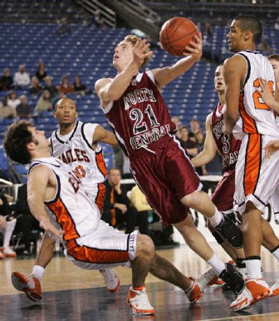 
North Central's Eric Beal moves between West Valley's Cameron Wieber, left, and Maurice Swan. 
 (John Froschauer Special to / The Spokesman-Review)