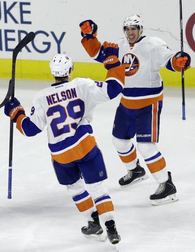 New York Islanders' Brock Nelson, left, and Travis Hamonic celebrate Hamonic's goal against the Carolina Hurricanes. (Associated Press)