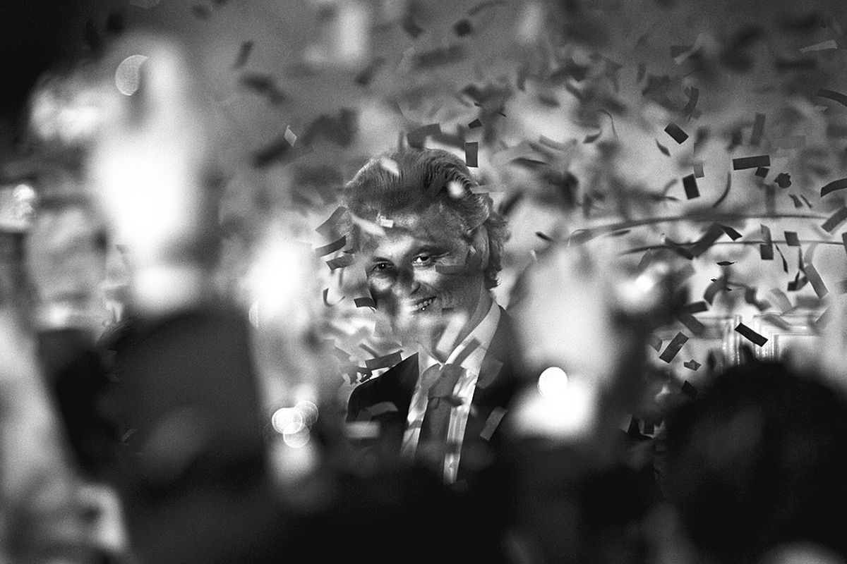 Populist anti-Islam leader Geert Wilders, center, reacts as ticker tape rains down during election night in The Hague, Netherlands, Wednesday.  (Associated Press)