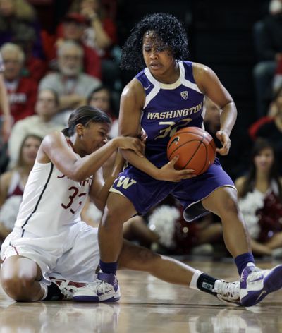 Washington’s Jazmine Davis takes Stanford’s Amber Orrange for a ride during second-half action Saturday. (Associated Press)