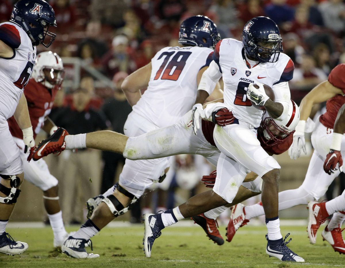 Arizona quarterback Jerrard Randall (with ball) is known more for his running ability, averaging 11.2 yards a carry (<!-- no photographer provided --> / AP)